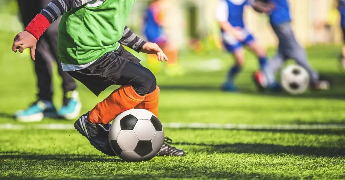 Youth soccer players competing for the ball